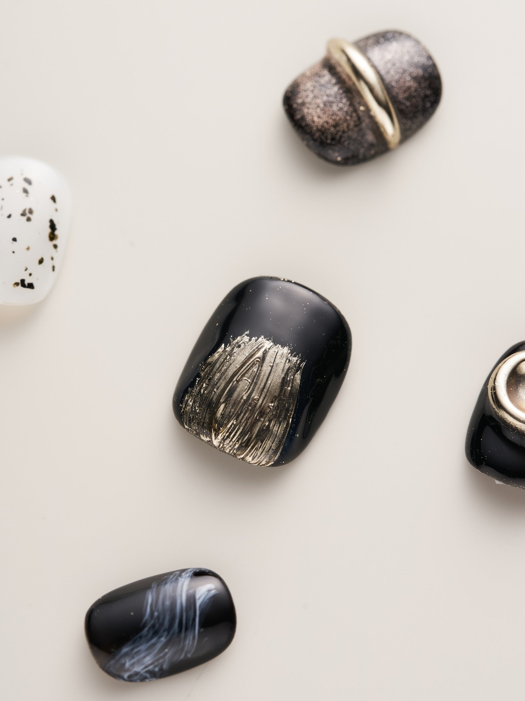 Detailed focus on Luxury Metallic Accent Squoval Press-On Nails featuring a sleek blend of black and metallic finishes, showcasing 3D embellishments and stylish patterns.