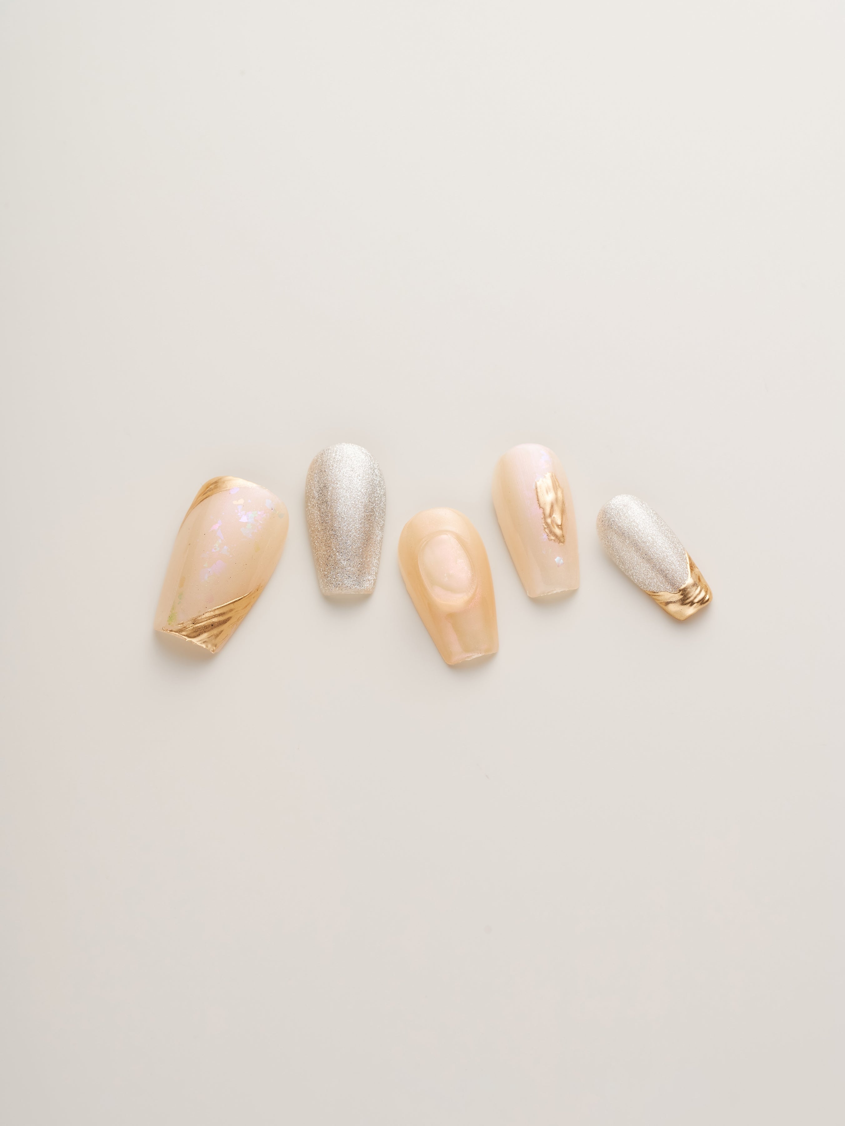 Luxe Golden Glow Press-On Nails set displayed, highlighting elegant designs and gold embellishments, perfect for special occasions or sophisticated everyday wear.