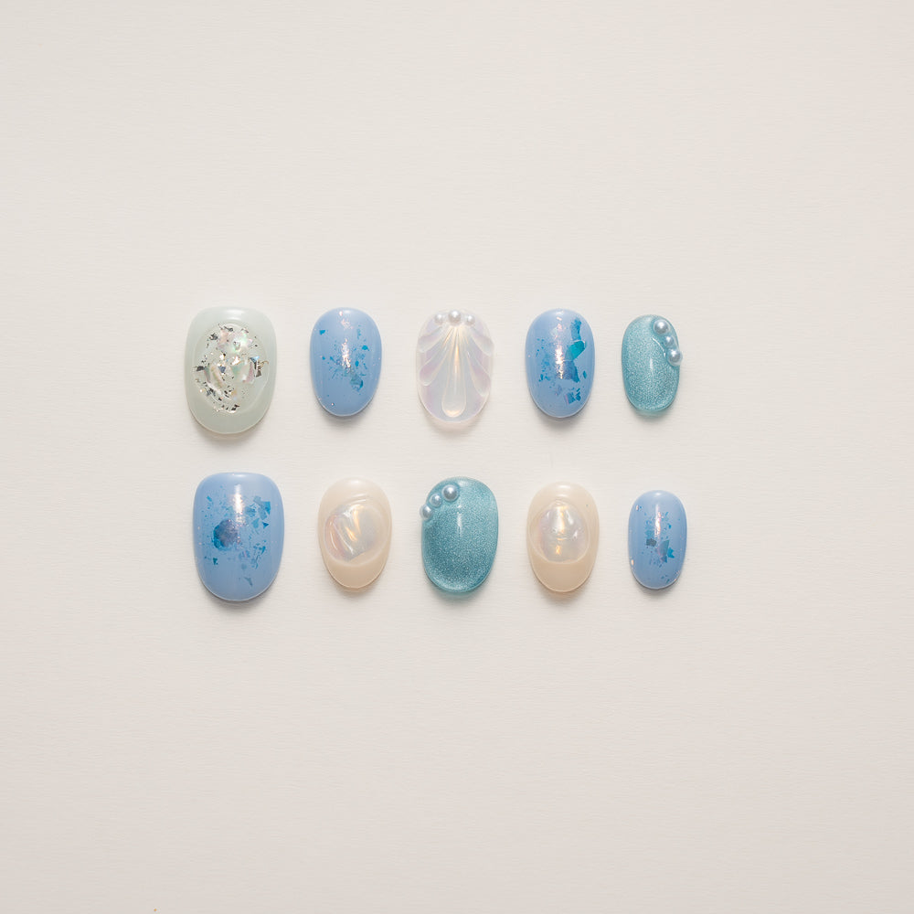 Iridescent Mermaid Glow Press-On Nails showcasing luxurious ocean-inspired design with 3D shell texture and pearl accents for an enchanting manicure.