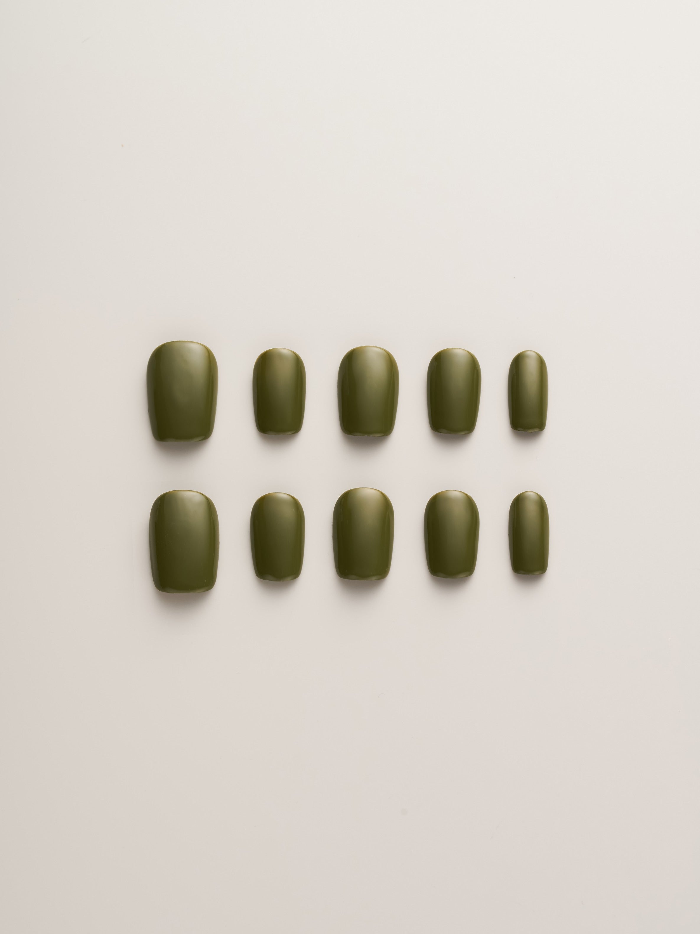 Minimalist Olive Green Squoval Press-On Nails set displayed in various sizes, perfect for a chic and versatile look.