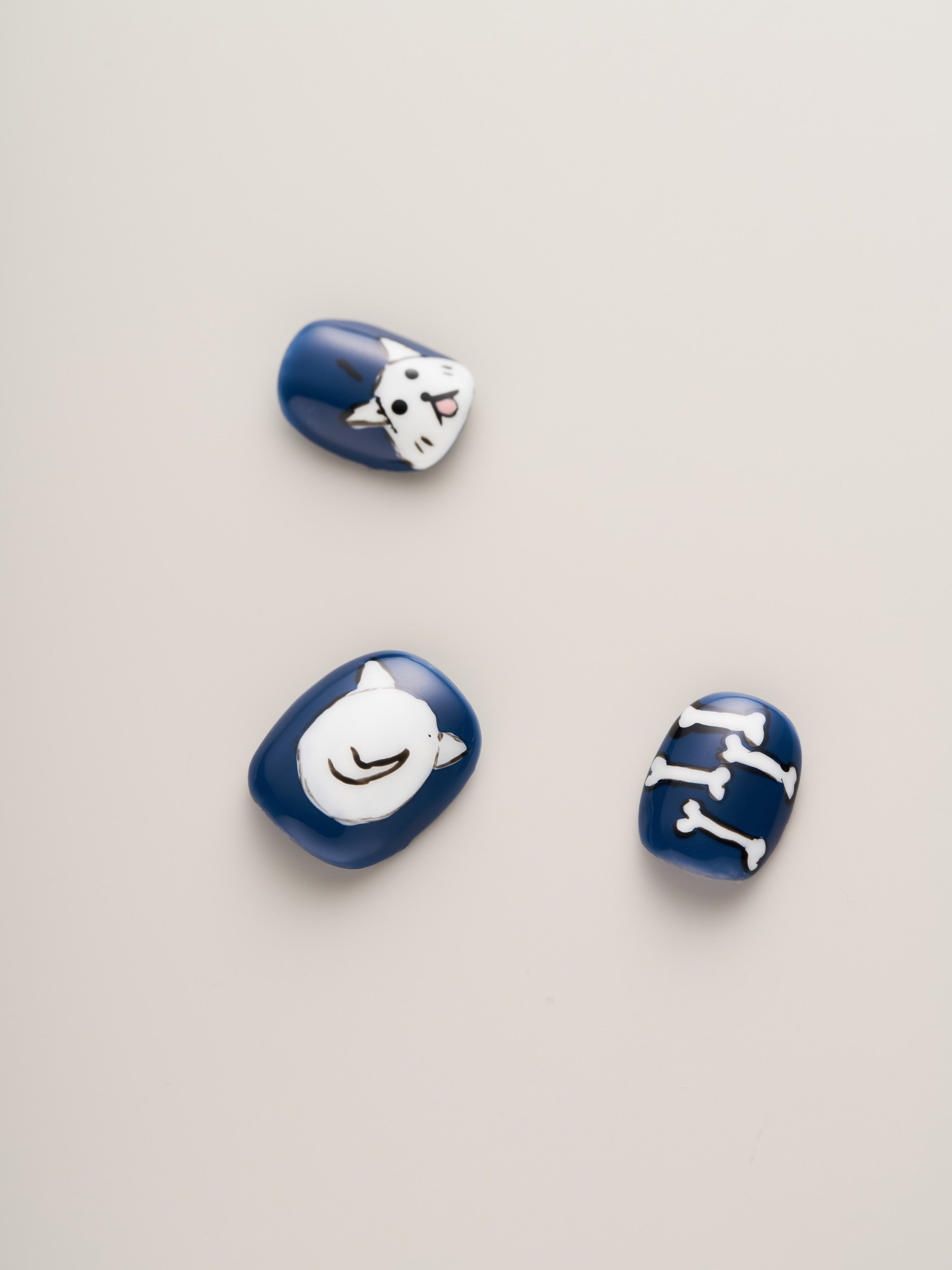 Stylish Bold Blue Dog Lover’s Squoval Press-On Nails displaying cute dog motifs and bone designs, perfect for dog lovers.