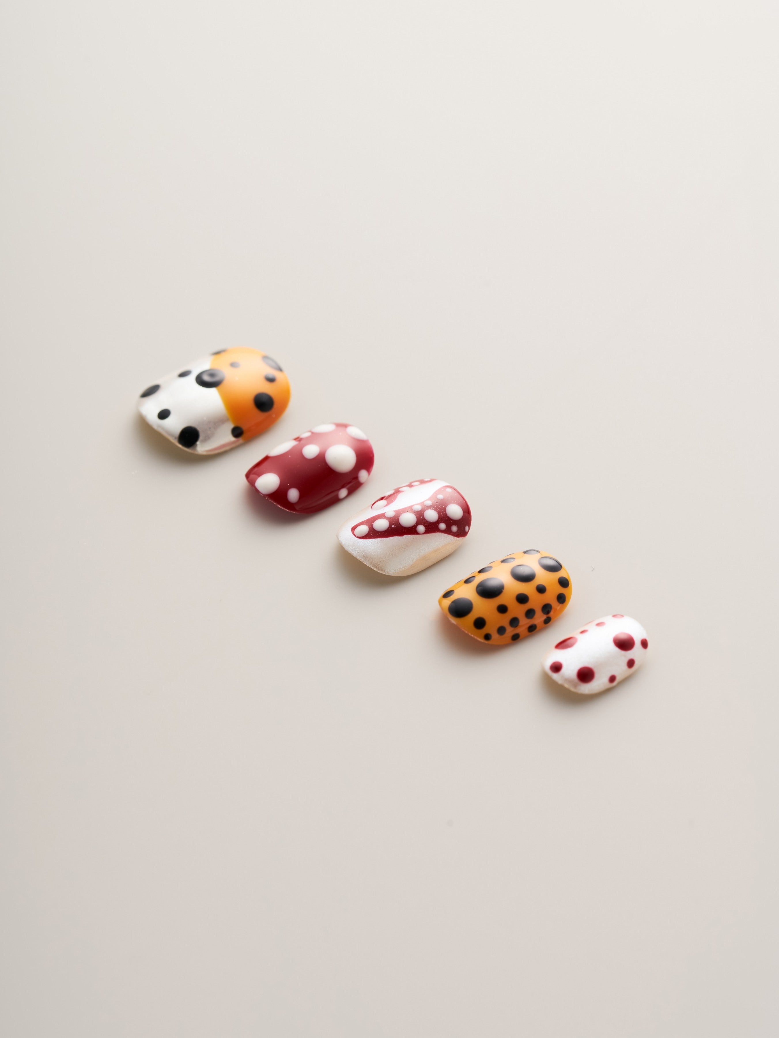 Close-up of Playful Polka Dot Squoval Press-On Nails showcasing vibrant colors and playful polka dots on a light background.