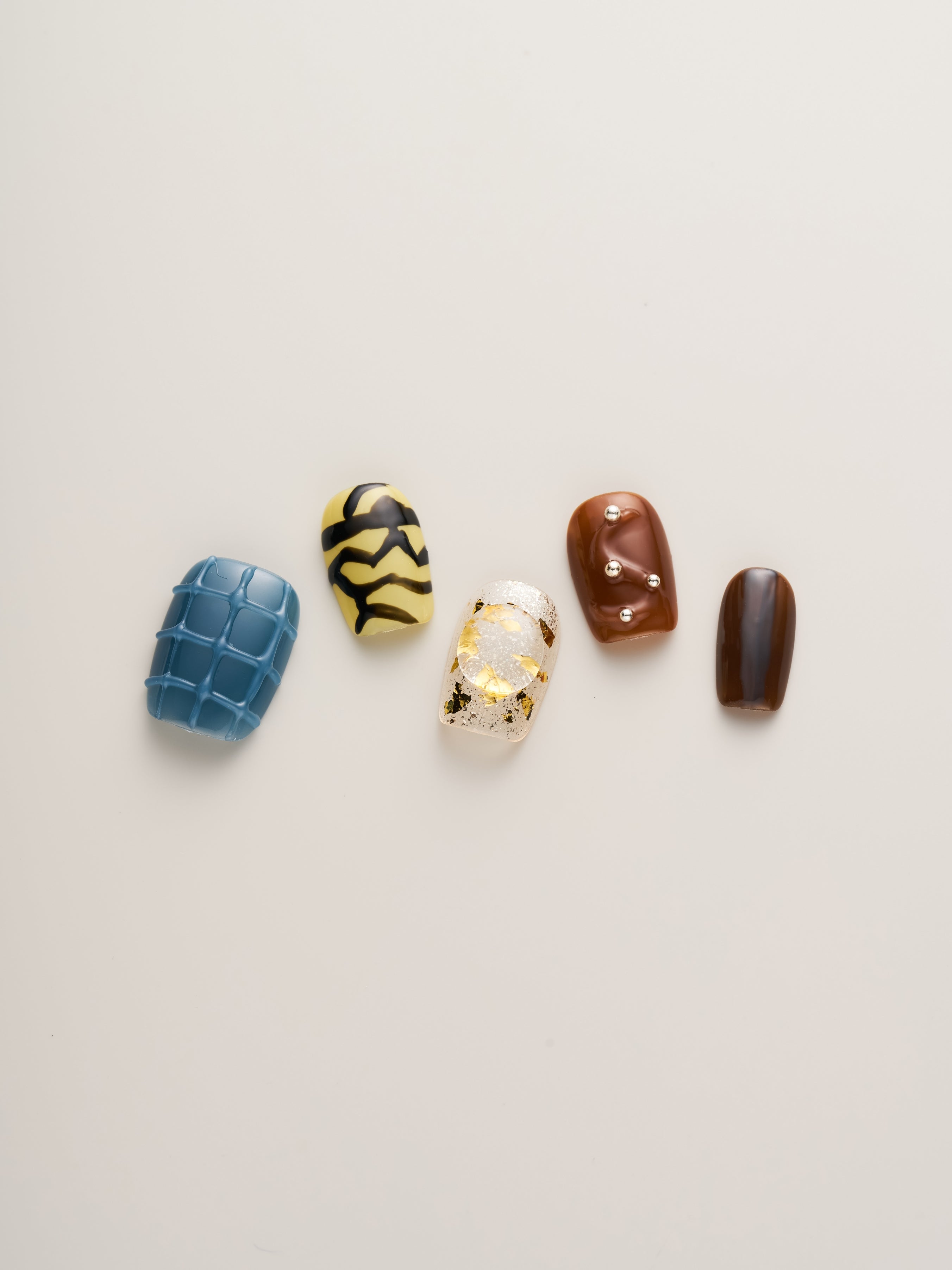 Close-up of Modern Abstract Squoval Press-On Nails featuring unique patterns and colors, perfect for a stylish and artistic look.