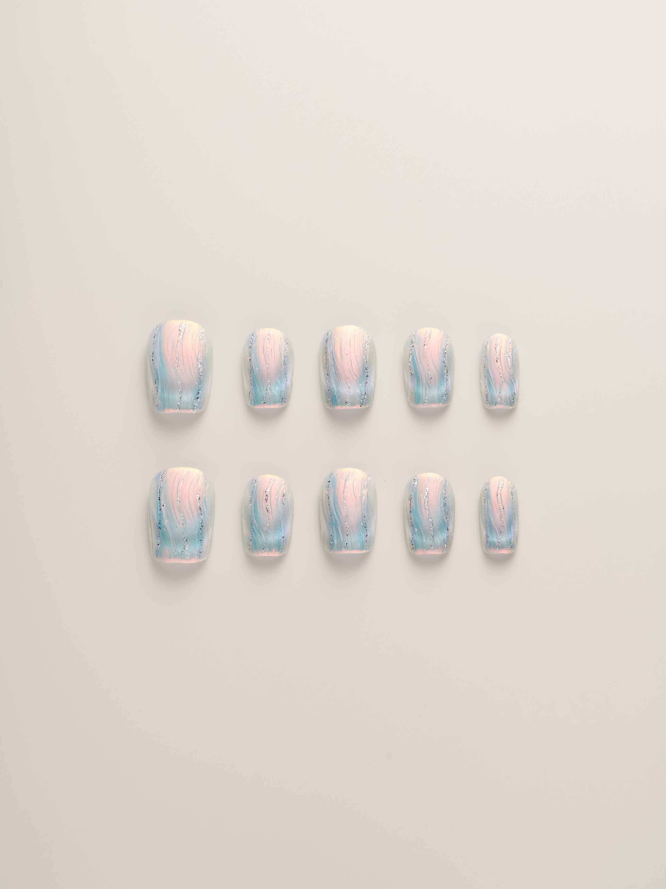 Iridescent Frosted Squoval Press-On Nails set featuring 10 nails in soft pastel hues with shimmering details, perfect for a glamorous look.