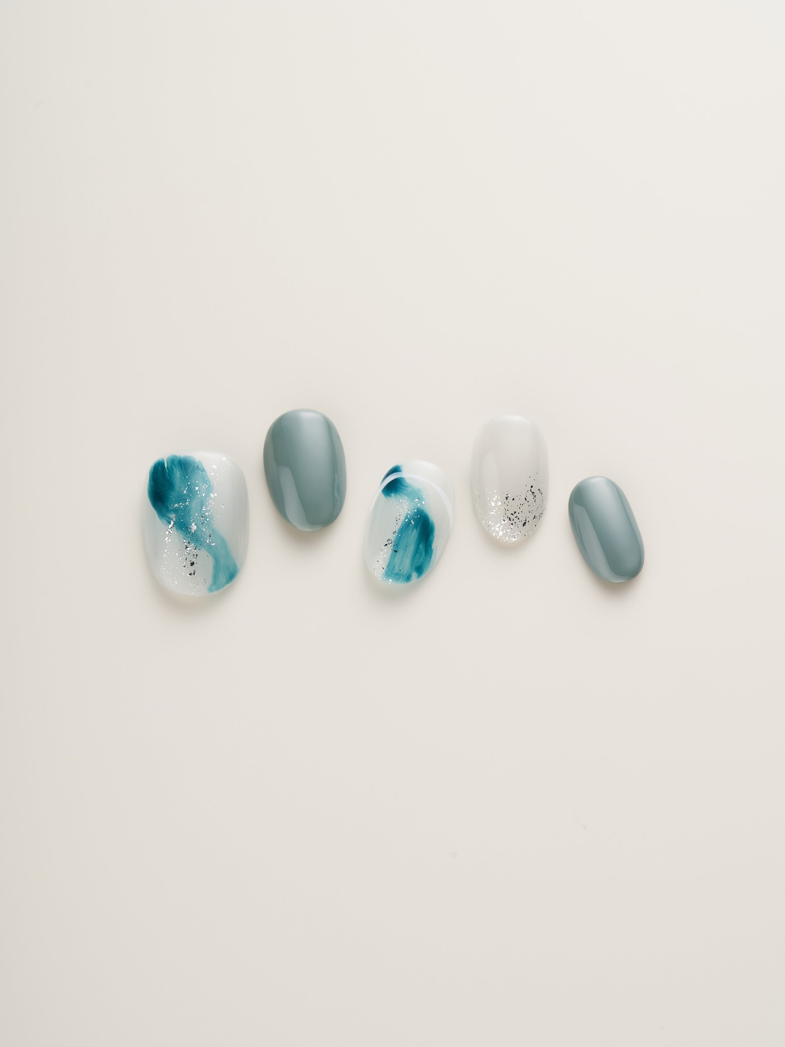 Close-up of Ocean Breeze Squoval Press-On Nails featuring ocean-inspired hues, perfect for a chic nail look.
