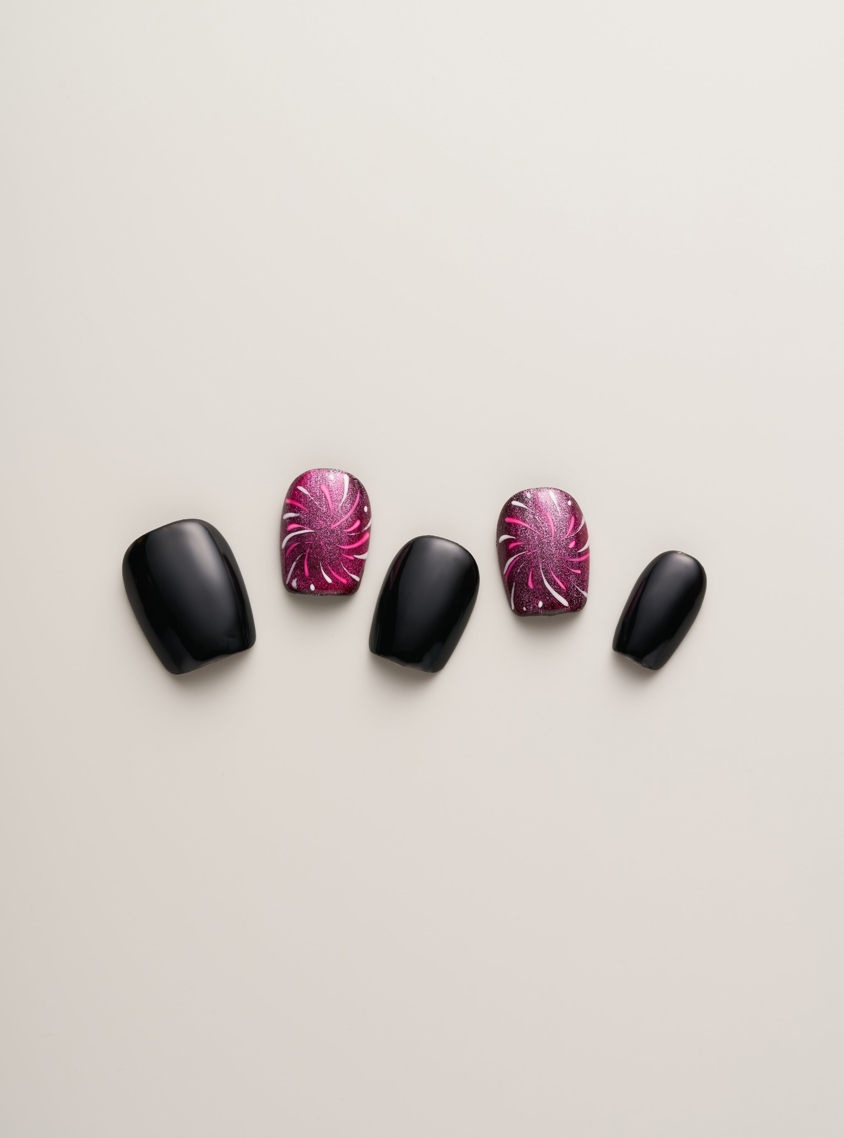 Midnight Spark Press-On Nails by Nailè displayed in a chic layout, highlighting the striking black and pink color scheme ideal for evening events.